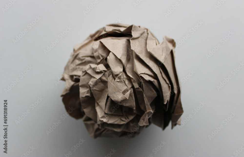 Pulp industry. Used wrapping paper ball isolated on white closeup view 
