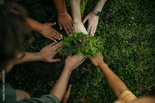 Close-knit group of pals enjoying a sunny day, hands in soil, sowing the seeds of friendship