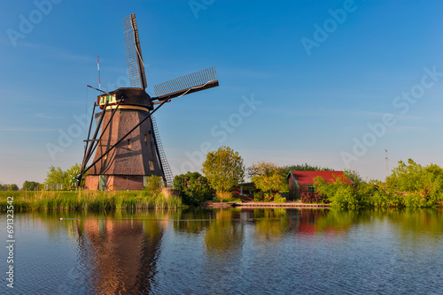 Traditional Romantic Dutch Windmills in Kinderdijk Village in the Netherlands With Water Canal.
