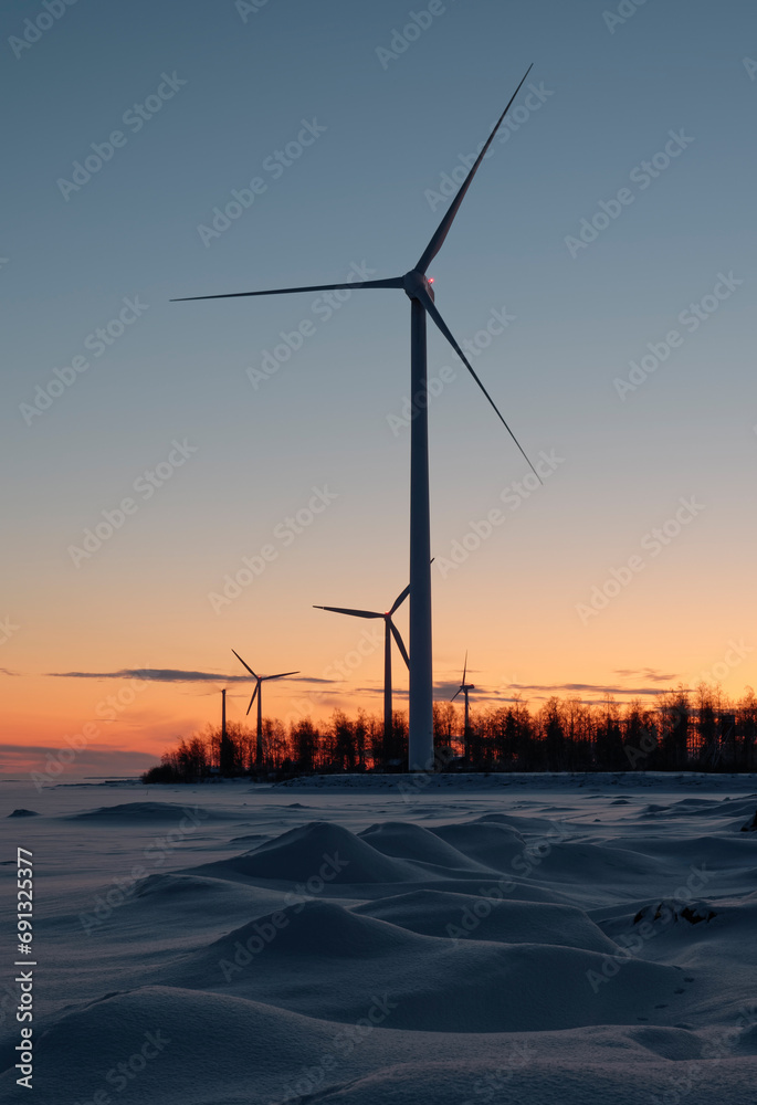 Renewable wind power generation on a wind farm on a cold winter morning in Northern Finland