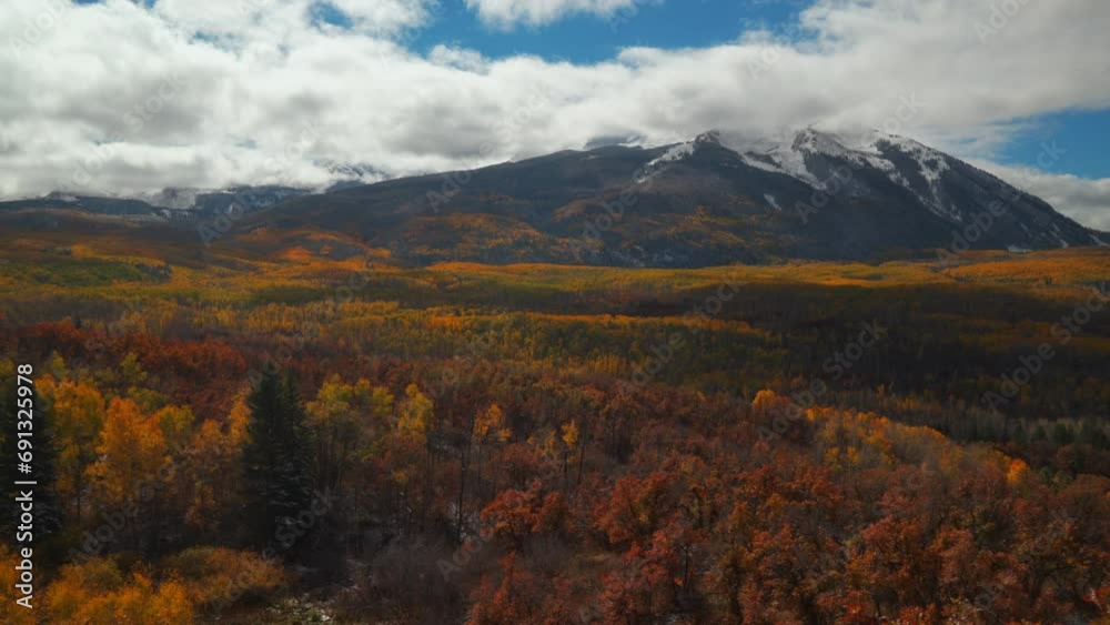 Kebler Pass Colorado cinematic frosted crisp cold frozen morning fall winter season collide first white snow red yellow orange aspen tree forest clouds blue sky Rocky Mountain peak stunning slow left Kebler Pass Colorado cinematic frosted crisp cold frozen morning fall winter season collide first white snow red yellow orange aspen tree forest clouds blue sky Rocky Mountain peak stunning slow left