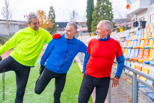 Old friends having fun stretching in a running track