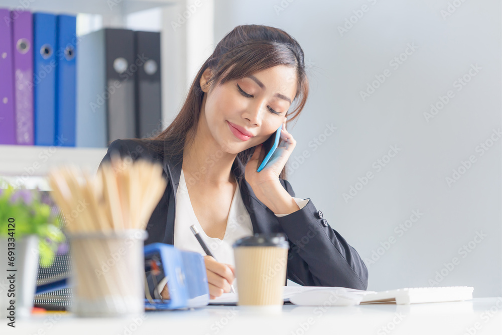 Portrait of Young business woman manager working at the office, Asian woman using smartphone in office Portrait of Young business woman manager working at the office, Asian woman using smartphone in office