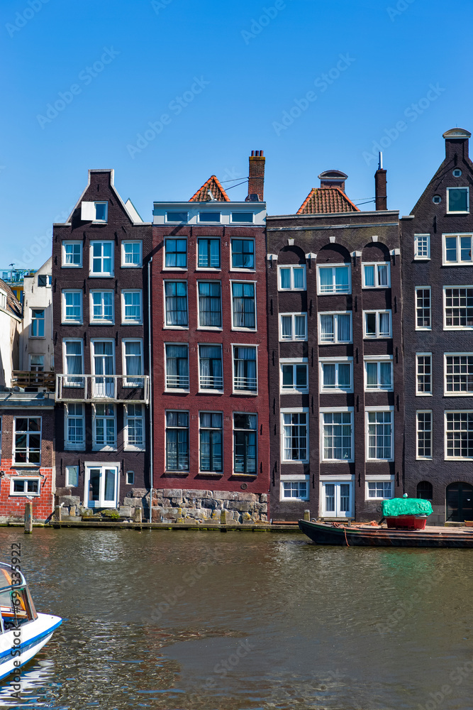 Holland Travel Ideas. Dancing Colorful Houses in Amsterdam Netherlands Over Amstel River as Landmark of Old European City.