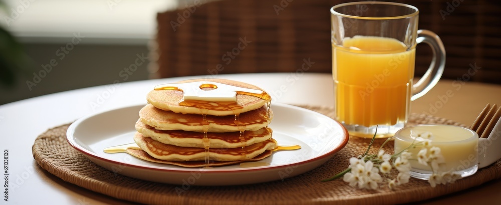 a plate of pancakes and a cup of milk is shown a plate of pancakes and a cup of milk is shown