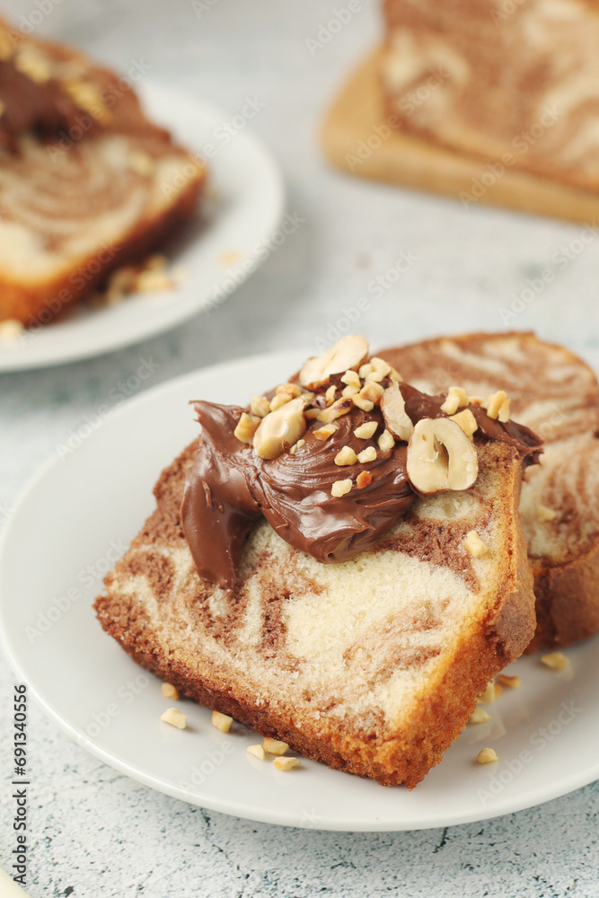 A piece of marble biscuit with chocolate cream and nuts A piece of marble biscuit with chocolate cream and nuts