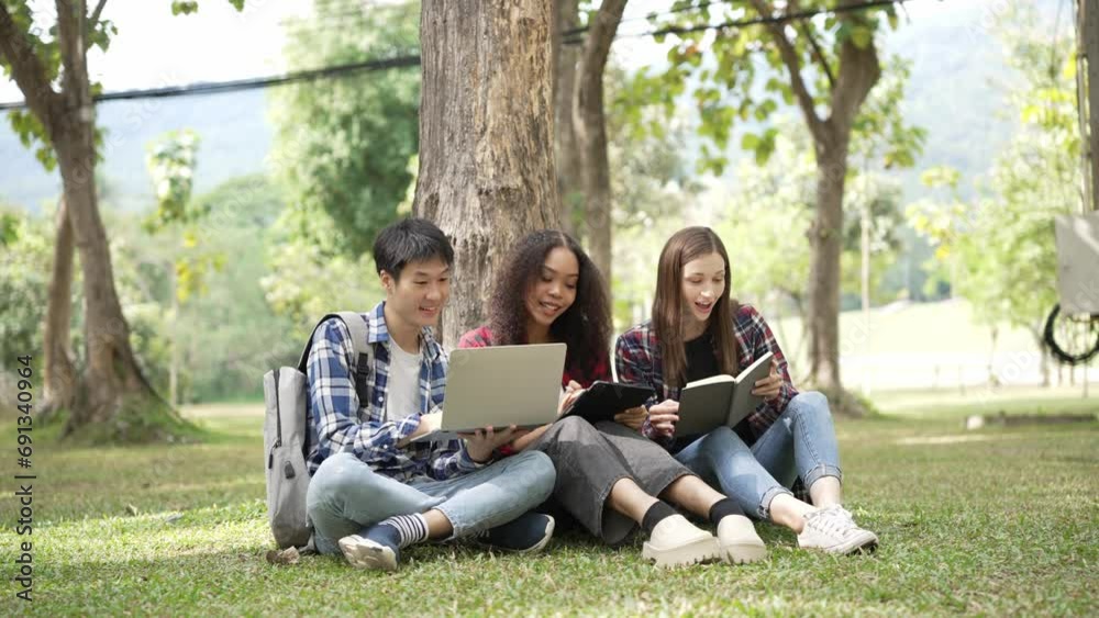Several generations of bright young students are preparing for exams in the park. read books together and use laptop Education concept, smart student is having happy outdoor lesson with teacher. Several generations of bright young students are preparing for exams in the park. read books together and use laptop Education concept, smart student is having happy outdoor lesson with teacher.