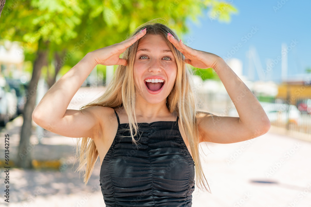 Young blonde woman at outdoors with surprise expression Young blonde woman at outdoors with surprise expression