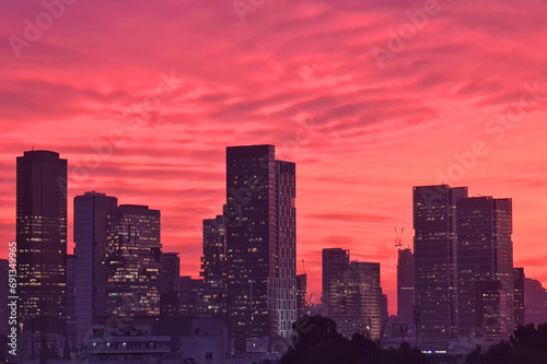 Skyline of Tel Aviv city at sunset  Israel. Cityscape abstract pink background. Pink sky with clouds over the city  panoramic view. Sunset over Tel Aviv  Israel
