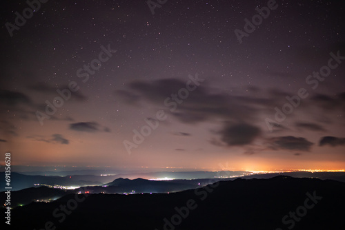 City lights seen from above. Light pollution covering the night sky. Amazing view with the artificial lights observed from a high point