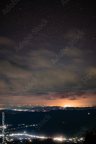 City lights seen from above. Light pollution covering the night sky. Amazing view with the artificial lights observed from a high point