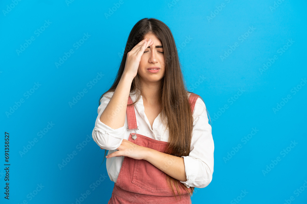 Young caucasian woman isolated on blue background with headache Young caucasian woman isolated on blue background with headache