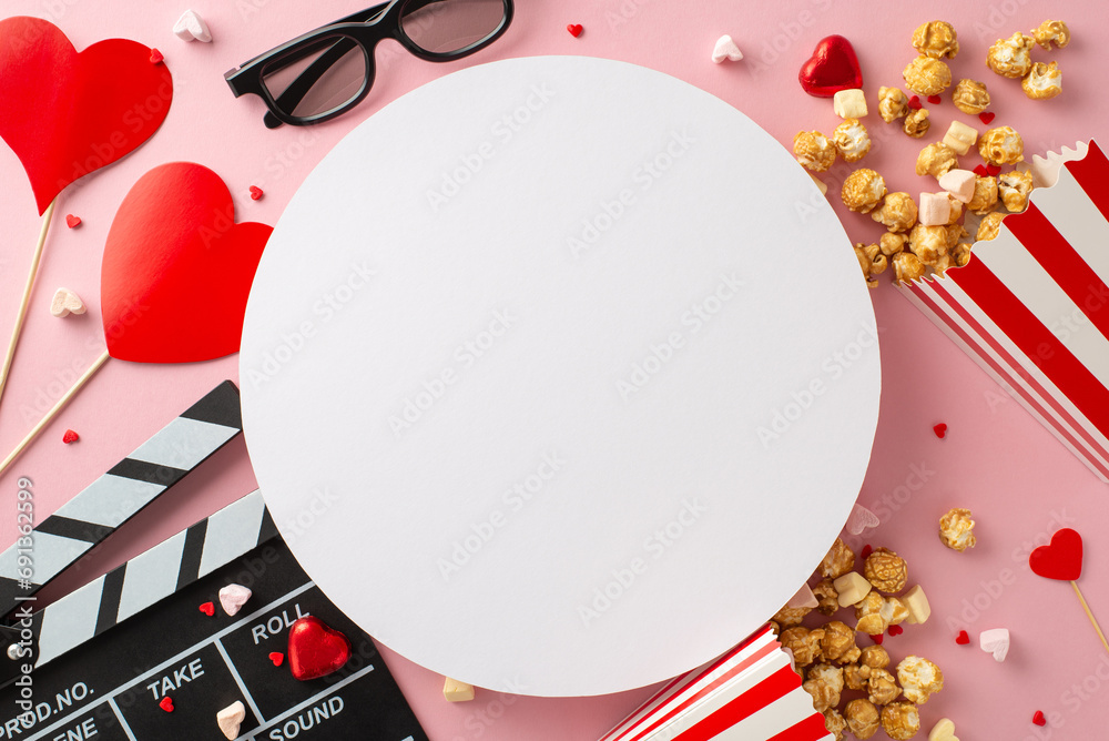Valentine's cinema dream. Top-view clapper, 3D glasses, popcorn boxes, heart decor, candies, sweets on delightful pastel pink background, setting mood for memorable evening. Empty circle for advert