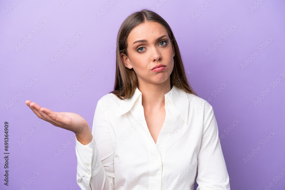 Young caucasian woman isolated on purple background having doubts Young caucasian woman isolated on purple background having doubts