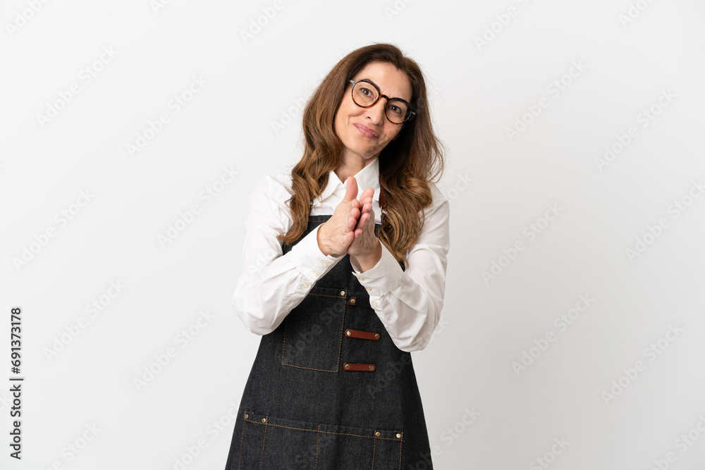 Restaurant middle aged waiter woman isolated on white background applauding after presentation in a conference Restaurant middle aged waiter woman isolated on white background applauding after presentation in a conference