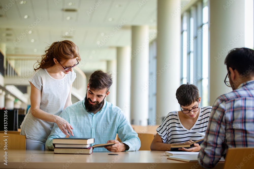 Students studying in library. Young success people are spending time together and learning together. Students studying in library. Young success people are spending time together and learning together.