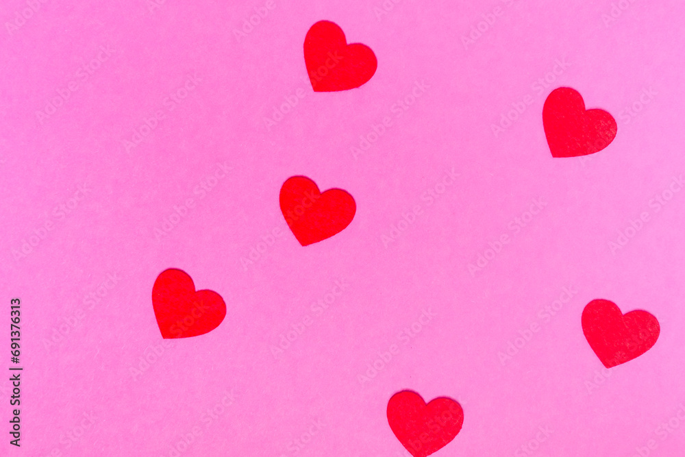 red hearts on a pink background for a greeting card or banner for Valentine's Day.