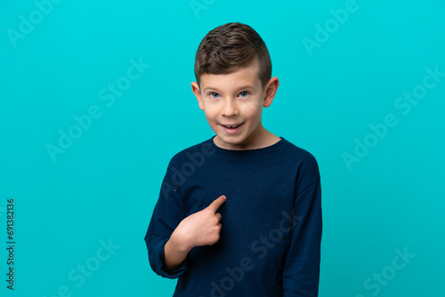 Little kid boy isolated on blue background with surprise facial expression