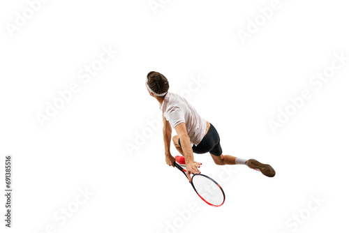 Top view. Concentrated and competitive young man practicing tennis, in motion with racket, playing isolated over white background. Concept of sport, hobby, active and healthy lifestyle, competition