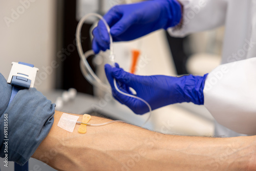 Inserting catheter into vein in patient's arm in hospital medicinal solution intravenously. photo