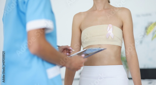 Doctor examination of female breast and oncology. Mammologist and breast cancer symptoms and diagnosis concept © H_Ko