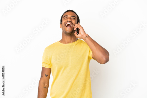 African American handsome man using mobile phone over isolated white background laughing