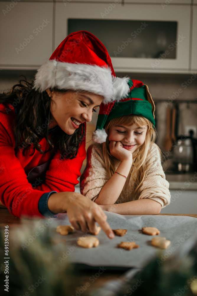Mother and child daughter girl are cooking cookies and having fun in the kitchen. Homemade food and little helper. Mother and child daughter girl are cooking cookies and having fun in the kitchen. Homemade food and little helper.