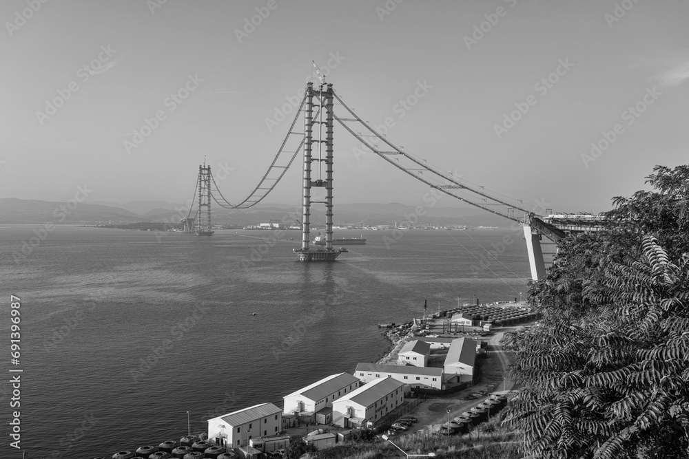 Fototapeta premium Osman Gazi Bridge (Izmit Bay Bridge). Izmit, Kocaeli, Turkey. Construction of a new road bridge continues across the Marmara Sea.