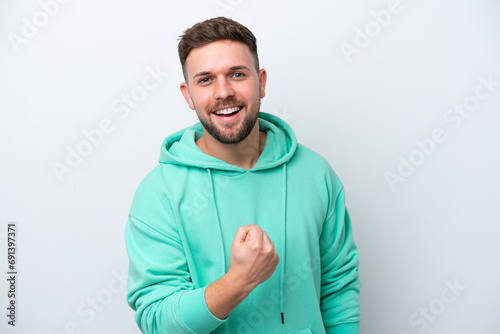 Fotografie Young caucasian man isolated on white background celebrating a victory