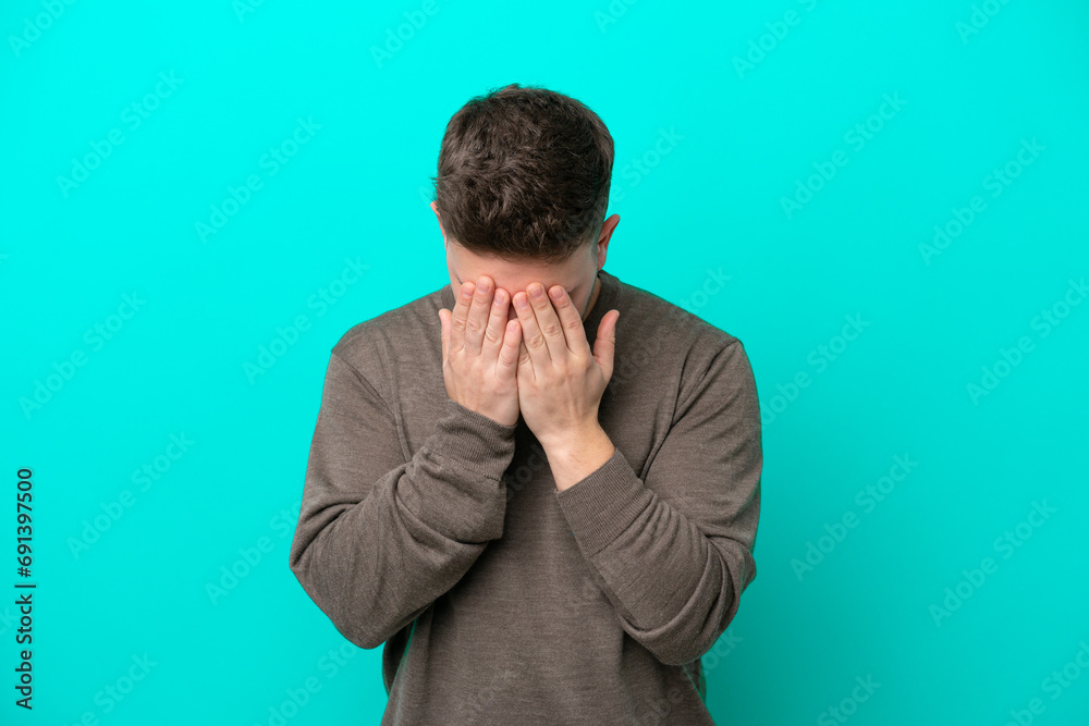Young caucasian man isolated on blue background with tired and sick expression Young caucasian man isolated on blue background with tired and sick expression