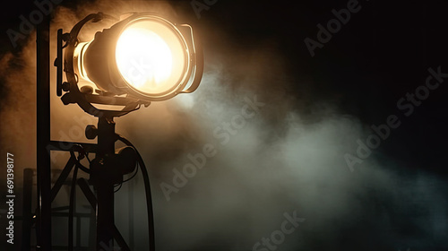  light flash coming from a flashlight on the dark, the spotlight on a stage with smoke coming out in teather, concer, during a music festival. Light comes from a stage with a band show