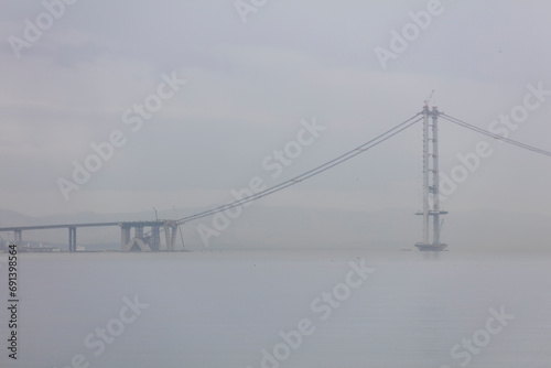 Osman Gazi Bridge (Izmit Bay Bridge). Izmit, Kocaeli, Turkey. Construction of a new road bridge continues across the Marmara Sea. photo