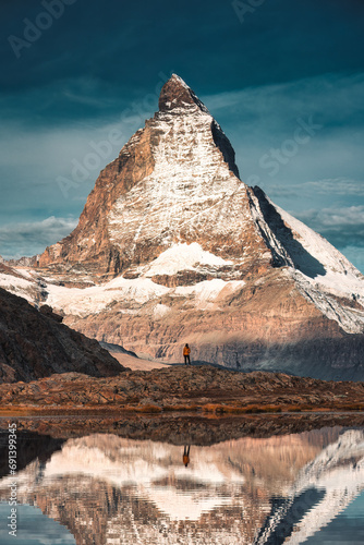 Matterhorn mountain with tourist standing reflecs in Riffelsee lake at Switzerland photo