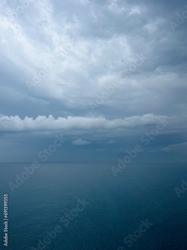 Dark rainy clouds at the sea, cloudy seascape, deep blue sea horizon © Oksana