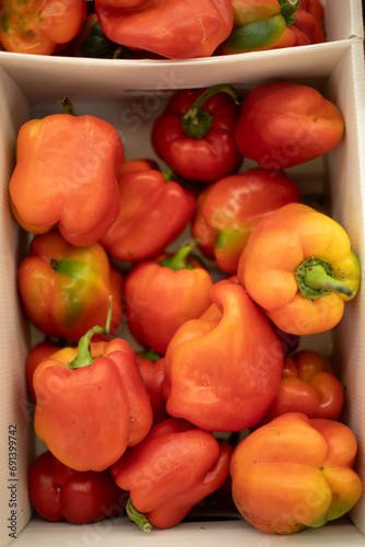 Red pepper in a box. Peppers on the market. Fresh vegetables.