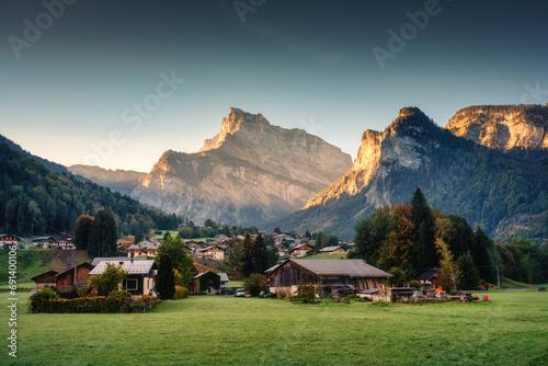 Peaceful village on hill with mountain range among French Alps at Sixt Fer a Cheval, France