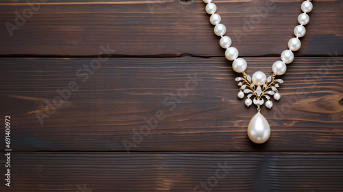 Pearl necklace with quartz on wood background photo