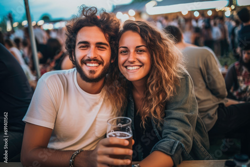 Couples enjoying festival, drinking beer and spending quality time together. Music festivals in America, Europe. Summer time. photo