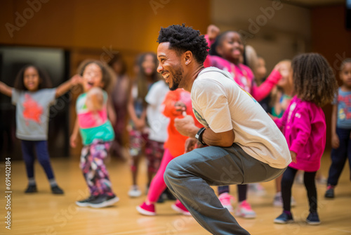 Hip-hop dancers at practice, smiling, singing. Teacher is teaching children how to dance Private dancing studio.