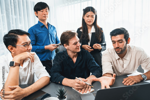 Group of diverse office worker employee working together on strategic business marketing planning in corporate office room. Positive teamwork in business workplace concept. Prudent