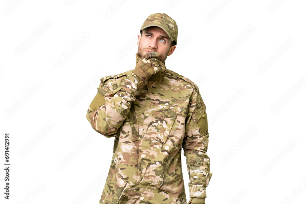 Military man over isolated chroma key background having doubts and with confuse face expression Military man over isolated chroma key background having doubts and with confuse face expression