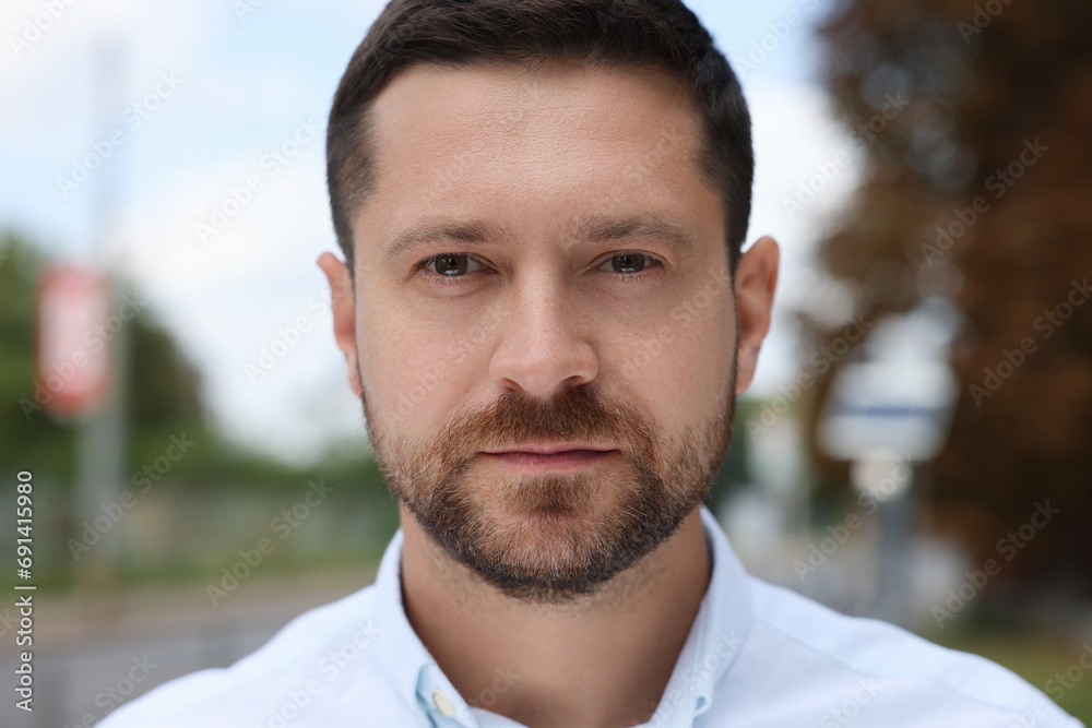 Portrait of handsome man looking at camera outdoors Portrait of handsome man looking at camera outdoors