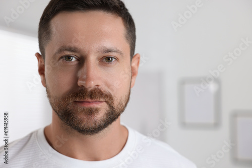 Portrait of handsome man on blurred background, space for text