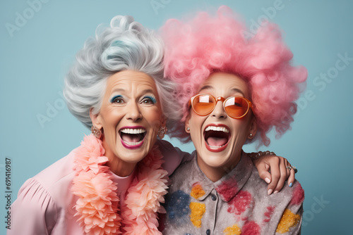Two funny ladies with colorful hairstyles on a blue background.