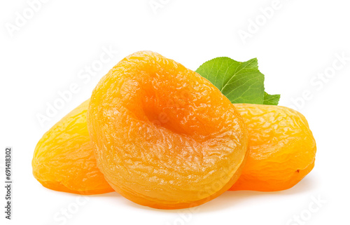 Pile of dried apricots with a leaf close-up on a white background. Isolated