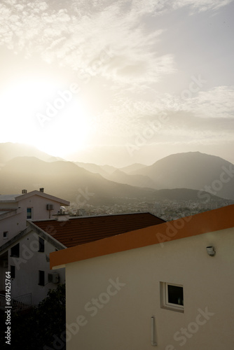 Sunrise over the mountains and the city in Montenegro. vertical photo