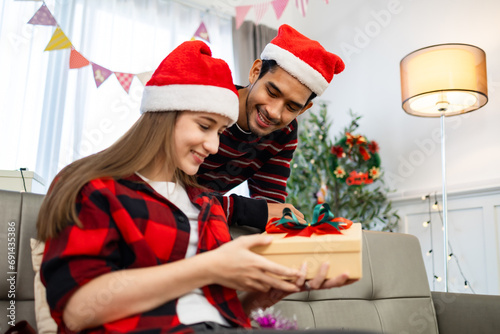 Asian young woman getting surprise gift from her girlfriend at home. Gives a Christmas gift, birthday gift, New year day celebration