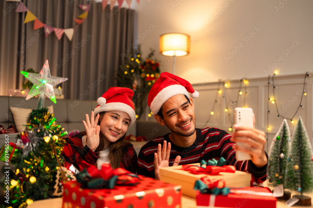 Female Christmas portrait indoors. Woman using phone for video call and selfie. . Person with Christmas tree at home. Female Christmas portrait indoors. Woman using phone for video call and selfie. . Person with Christmas tree at home.