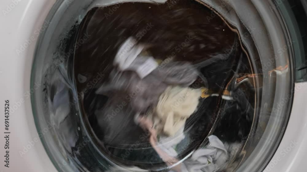 Close-up of washing machine in the process, wash clothes in the washing machine.