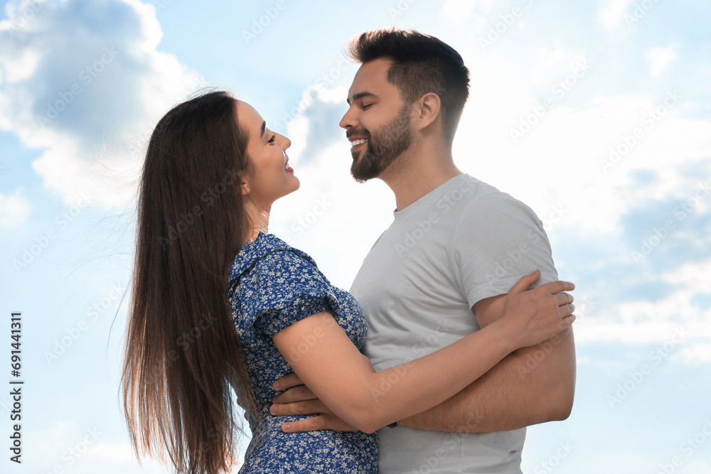 Obraz premium Romantic date. Beautiful couple spending time together against blue sky
